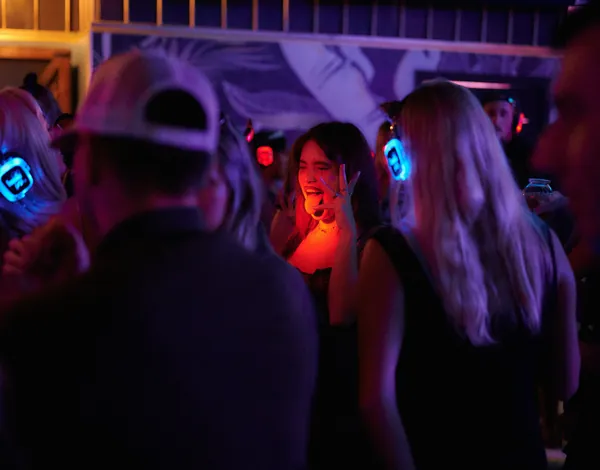 Guests singing together in blue light