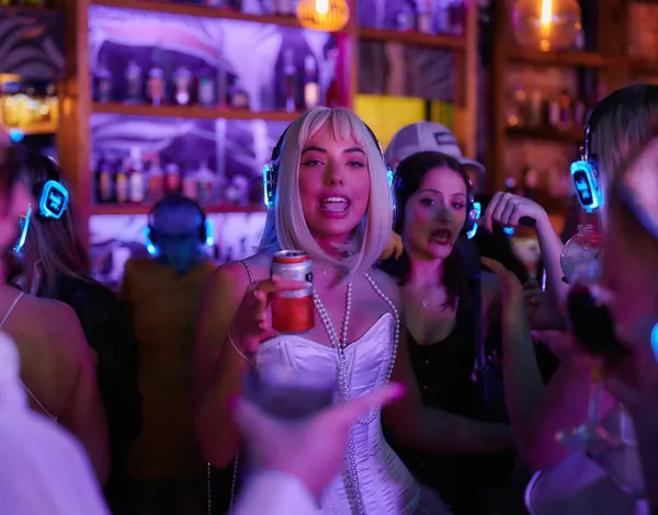 A guest with a cocktail in the middle of the dancefloor